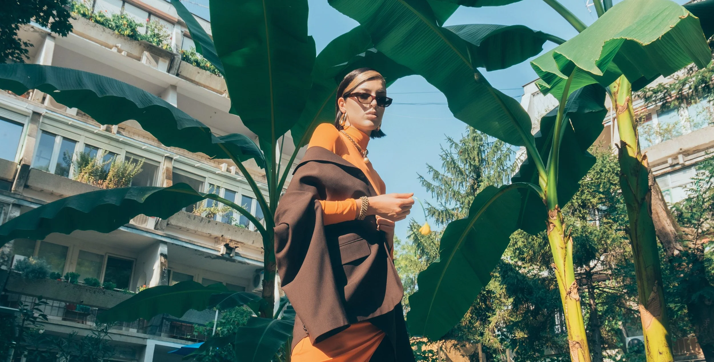 Fashion Model In Front Of Greenery Background