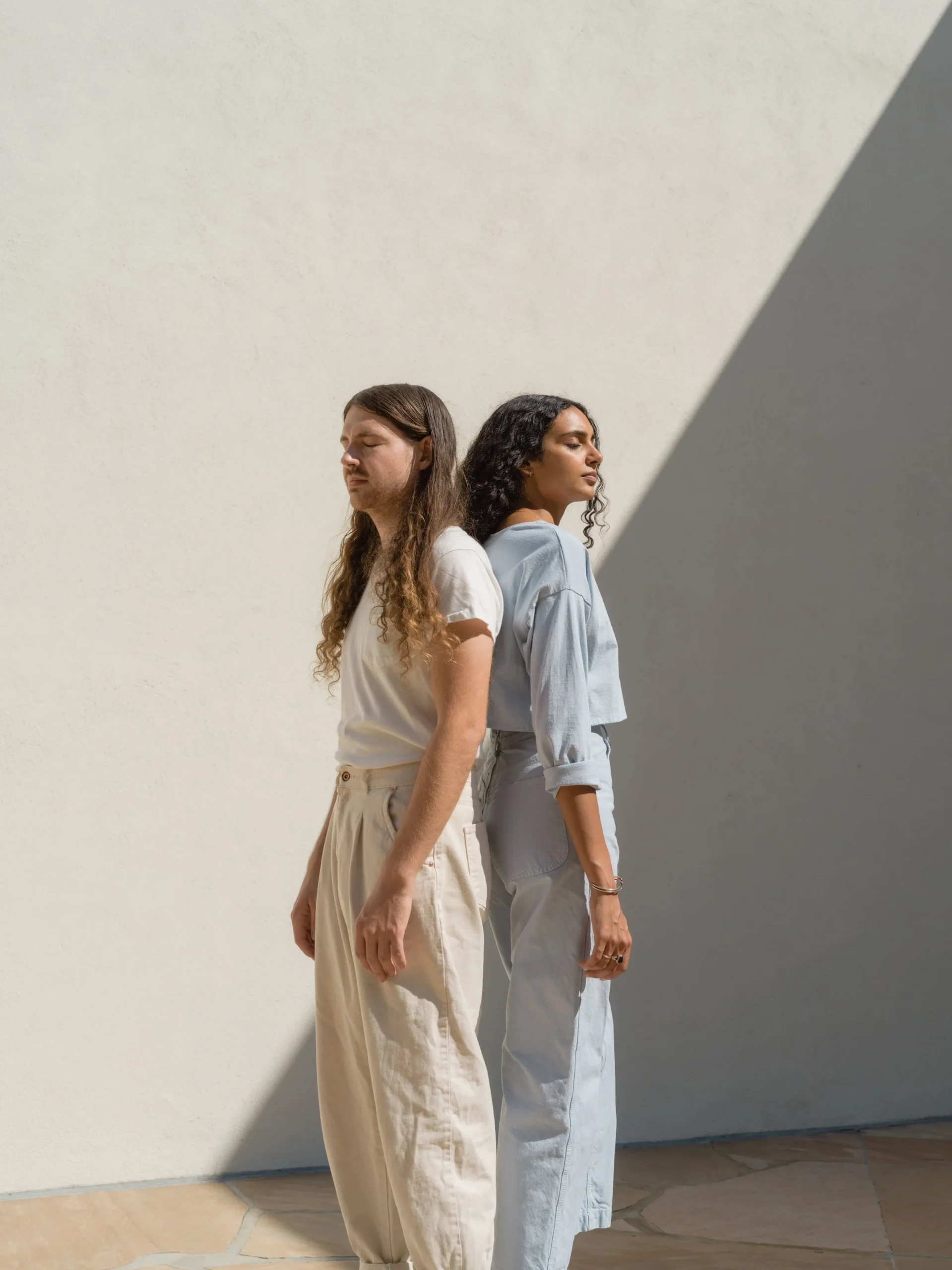 Trendy Man And Woman Standing With Shadow